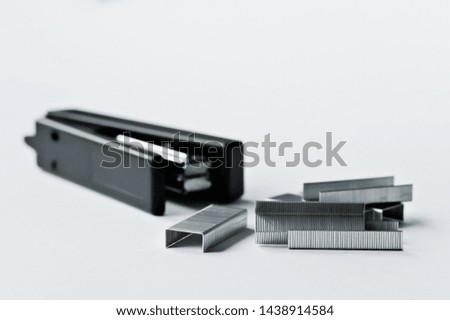 Stapler black with paper clips isolated on white background. Office accessories
