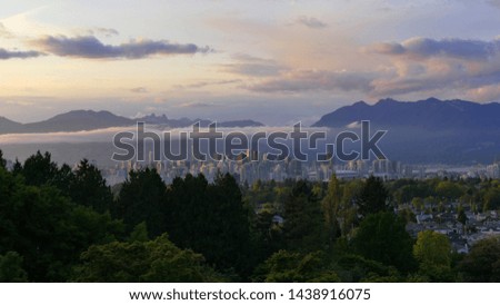 Western Canada. British Columbia. Vancouver City Downtown from Queen Elisabeth Park on Cloudy Sunset Twilight.