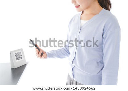 Young woman paying with digital money