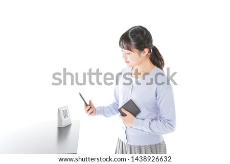Young woman paying with digital money