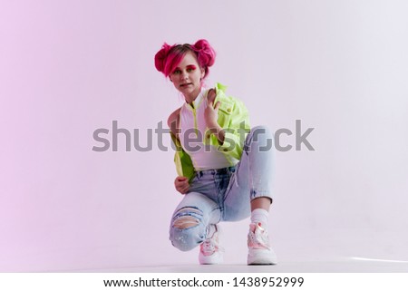 woman in a green jacket sits on his haunches