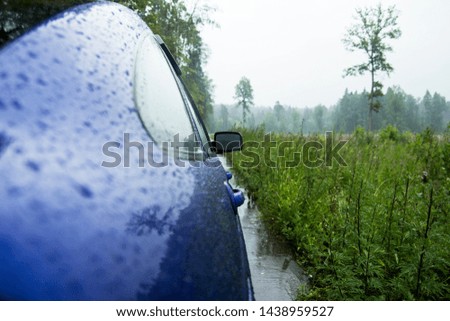 Car in the rain. Headlights front rear windshield.