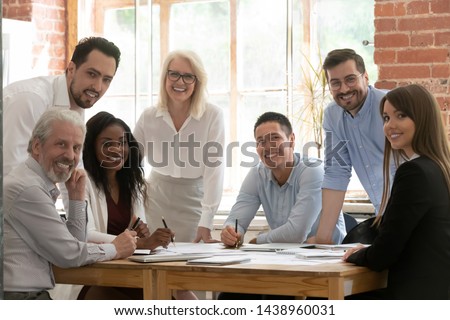 Professional business team young and old people posing together at office table, happy diverse leaders employees looking at camera, smiling multiracial staff corporate people workers group portrait Royalty-Free Stock Photo #1438960031