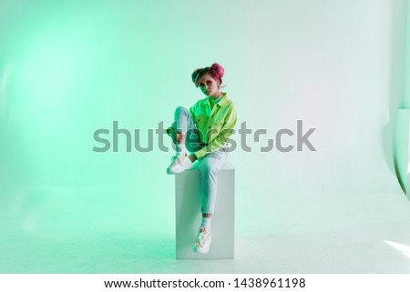 woman in green jacket sitting on the stove