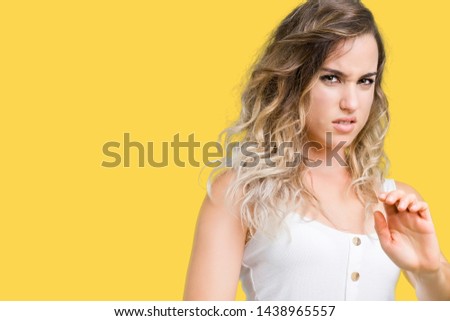 Young beautiful blonde woman over isolated background disgusted expression, displeased and fearful doing disgust face because aversion reaction. With hands raised. Annoying concept.