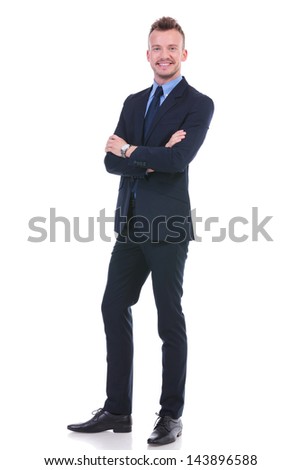 full length picture of a young business man standing with his arms folded while smiling for the camera. on white background