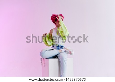 woman with pink hair sitting