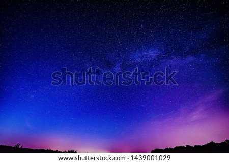 Midsummer Milky Way and satellite light in the night sky.
