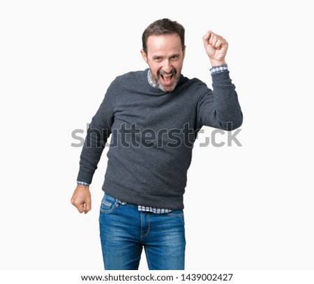 Handsome middle age senior man wearing a sweater over isolated background Dancing happy and cheerful, smiling moving casual and confident listening to music