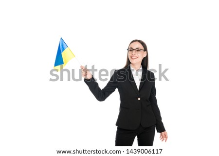 smiling businesswoman in black suit holding American flag isolated on white