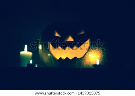 candles and pumpkin for Halloween on dark background