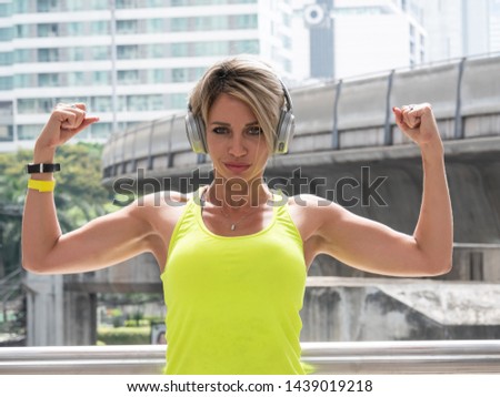 Portrait of fit and sporty caucasian woman exercise in city