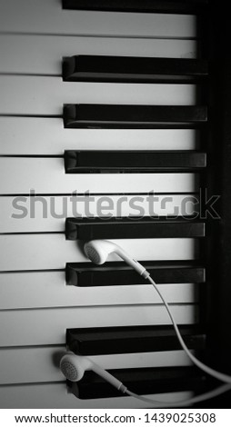  the earphones put on the piano