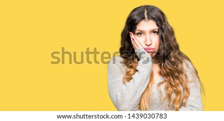 Young beautiful woman wearing winter dress thinking looking tired and bored with depression problems with crossed arms.