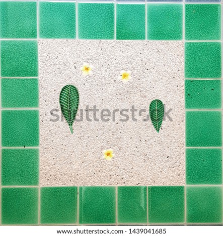 the floor design in green mosaic frame and decorate with green leaves and white flowers inside