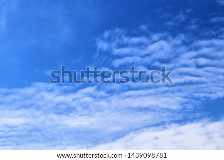 Beautiful fluffy white clouds in a deep blue sky on a summer day