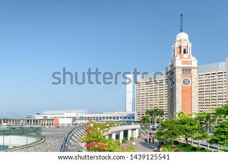 Scenic view of the Clock Tower (Former Kowloon-Canton Railway Clock Tower) in Tsim Sha Tsui of Hong Kong. Awesome cityscape on sunny day. Hong Kong is a popular tourist destination of Asia. Royalty-Free Stock Photo #1439125541