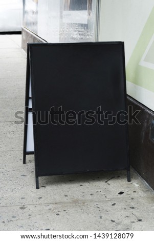 Standing billboard template in front of shop