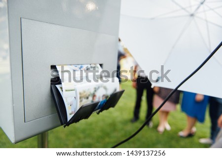 photo booth for instant photos at an outdoor wedding