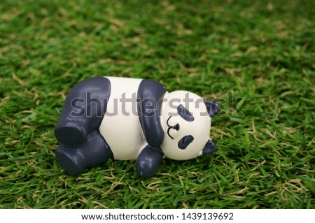 Sleeping Panda ornament on lawn