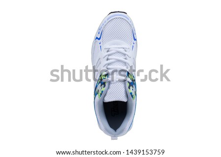 White sneakers with colorful accents on a white sole. Sport shoes on white background