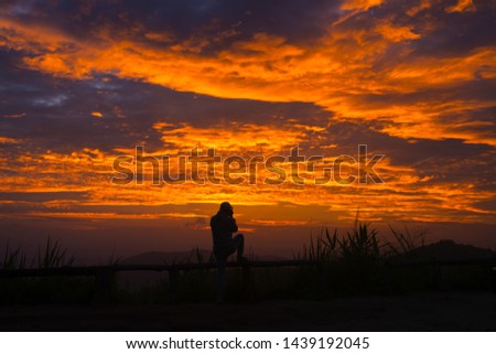 Photograph of beautiful sunset with orange clouds at Chiang Mai view point in Thailand.