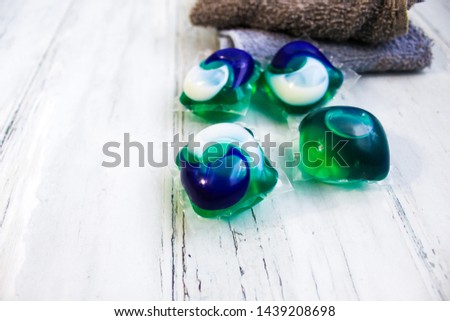 Laundry Day - laundry detergent pods on a laundry folding table with washcloths.