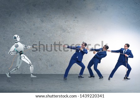 Competition between humans and robots in tug of war concept Royalty-Free Stock Photo #1439220341