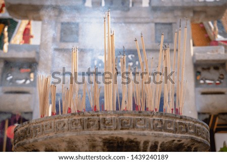 burning joss sticks in temple