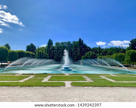 Beautiful outdoor water fountain with dancing waters on a sunny day in Battersea park, London  Royalty-Free Stock Photo #1439242397
