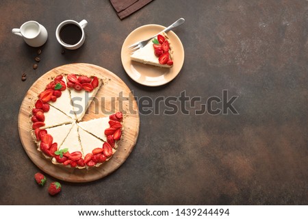 Cheesecake with fresh strawberries for dessert - healthy organic summer berry dessert cheesecake and coffee, copy space, top view. Homemade cheese cake. Royalty-Free Stock Photo #1439244494