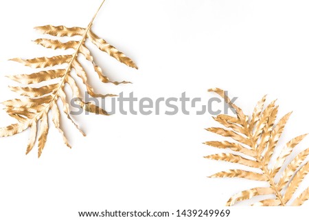 Flat lay of golden tropical leaf design elements. Decoration elements for invitation, wedding cards, valentines day, greeting cards. isolated over white background. Top view