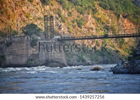 a photograph of a bridge and river