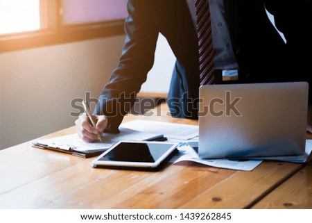 Business concept. Businessman manager working in modern office, make a deal, signing official contract with laptop computer, digital tablet.