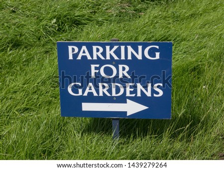 "Parking for Gardens" Sign with White Letters on a Blue Background in Rural Devon, England, UK