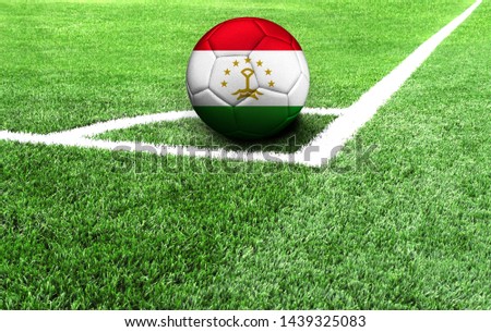 soccer ball on a green field, flag of Tajikistan