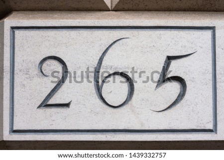 House number 265 with the two hundred and sixty five engraved in stone