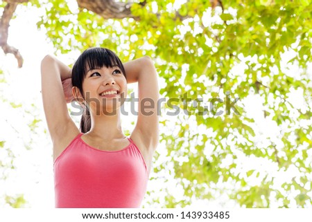 a young asian woman relaxing in the park