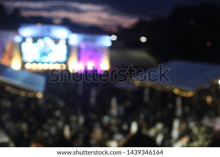 Defocused background of open air music festival concert event. Blurred stage and people.