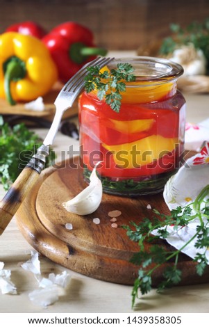 Pickled salad bell pepper in jar and ingredients. Rustic style