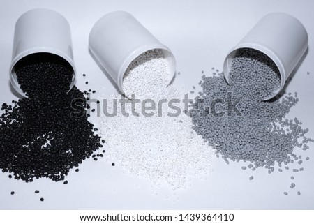 Glass with thermoplastic elastomer granules on white background Royalty-Free Stock Photo #1439364410