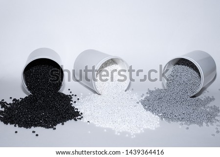 Glass with thermoplastic elastomer granules on white background Royalty-Free Stock Photo #1439364416