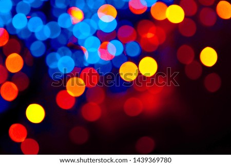 Colorful light circles bokeh festive glitter dark background. Holiday greeting cards, invitations, flyers, blog posts, banners design with copy space. Defocused.