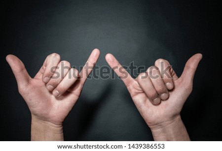 Hands making positive symbols with colourful background