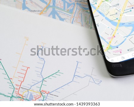 Smartphone with navigation map on metro map
