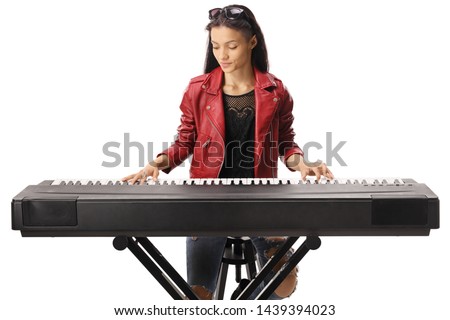 Young female playing a keyboard isolated on white background
