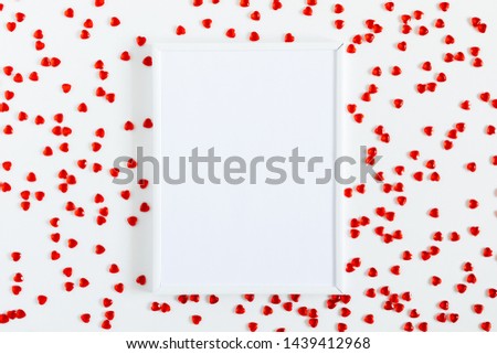 Composition Valentine's Day. Blank frame for text, red heart, confetti on white background. Valentine's Day concept. Flat lay, top view, copy space
