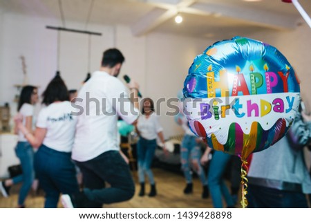An image of a group of friends having fun at a birthday party
