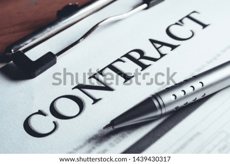 Close-up of silver pen put on the contract policy agreement papers. Legal contract signing.