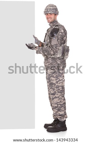 Happy Soldier Holding Placard Over White Background